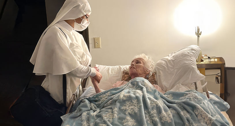 Servant Sisters of Mary caring for patient in bed